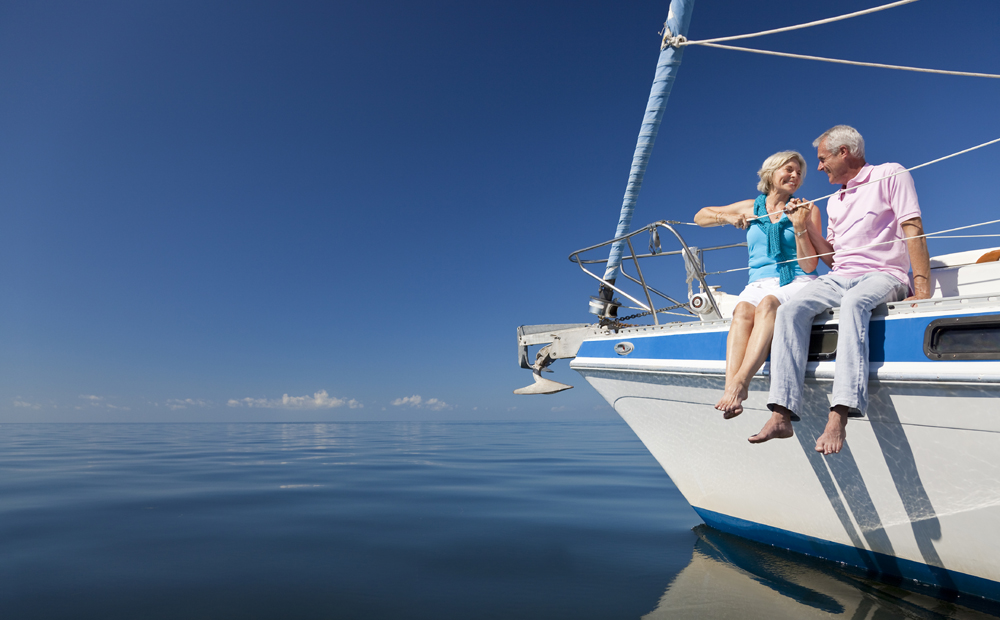 Happy Senior Couple on the Bow of a Sail Boat