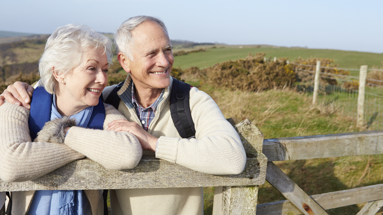 Senior Couple Walking Along Coastal Path