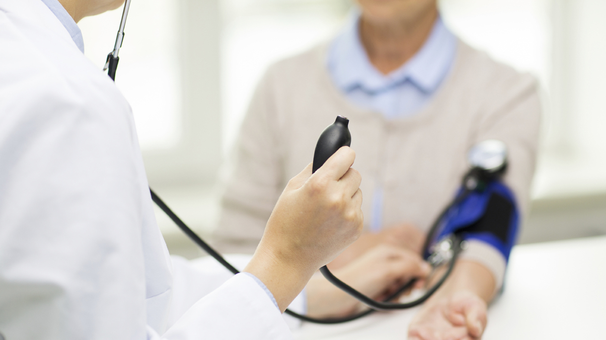 doctor with tonometer and senior woman at hospital
