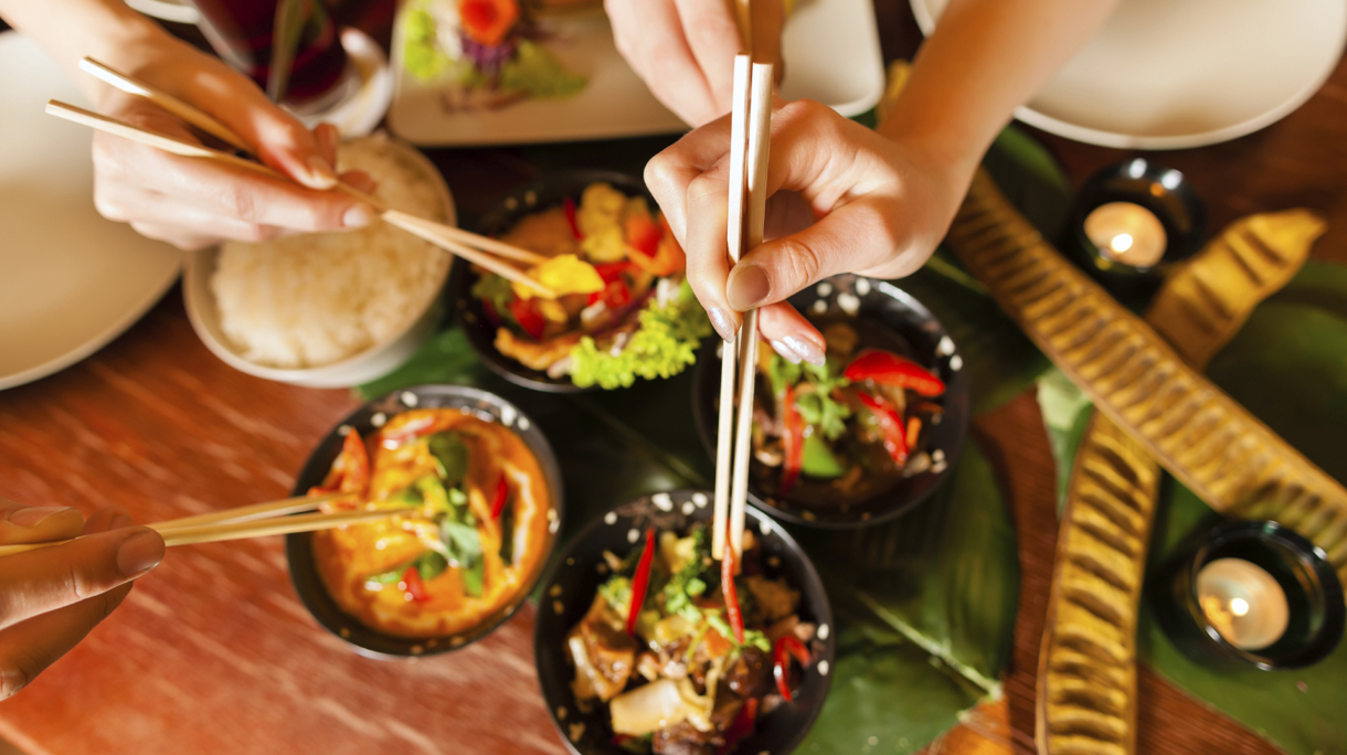 Young people eating in Thai restaurant