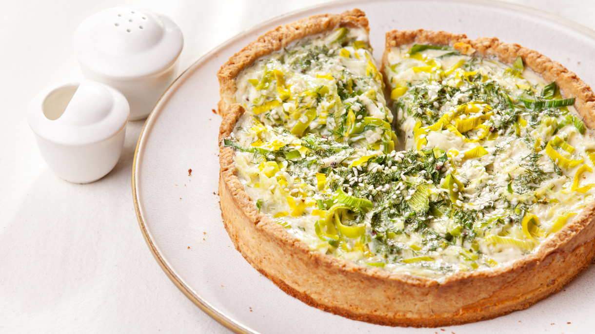 Leek quiche on white textured background