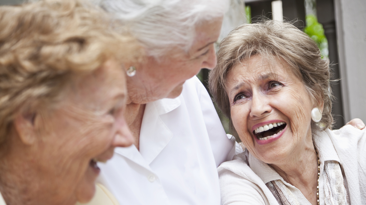 Three elderly women laughing