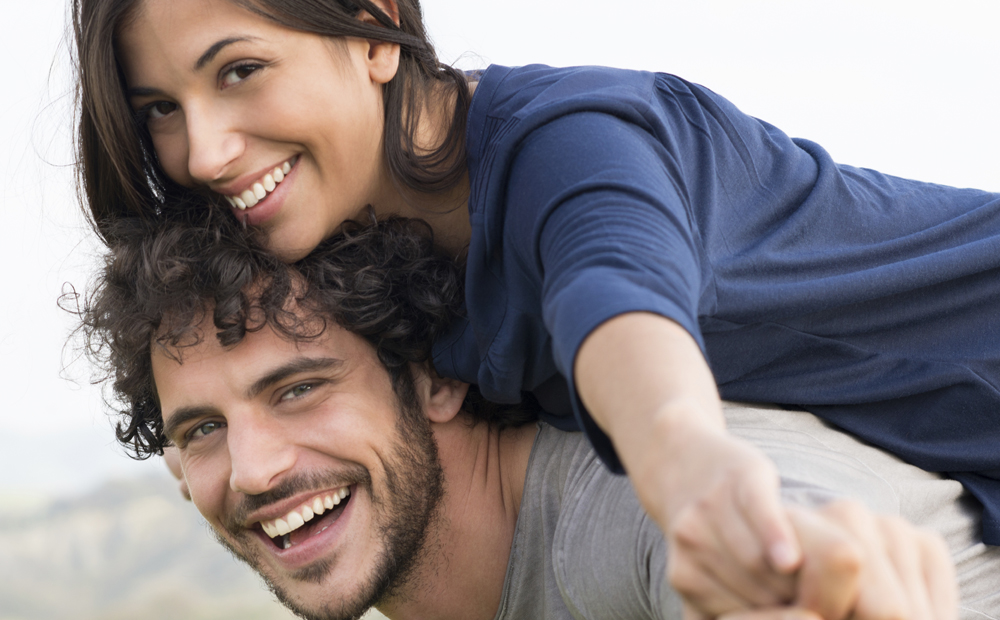 Man Giving Piggyback Ride To Woman