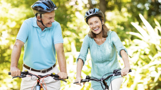Active Senior Couple With Bicycles In Park