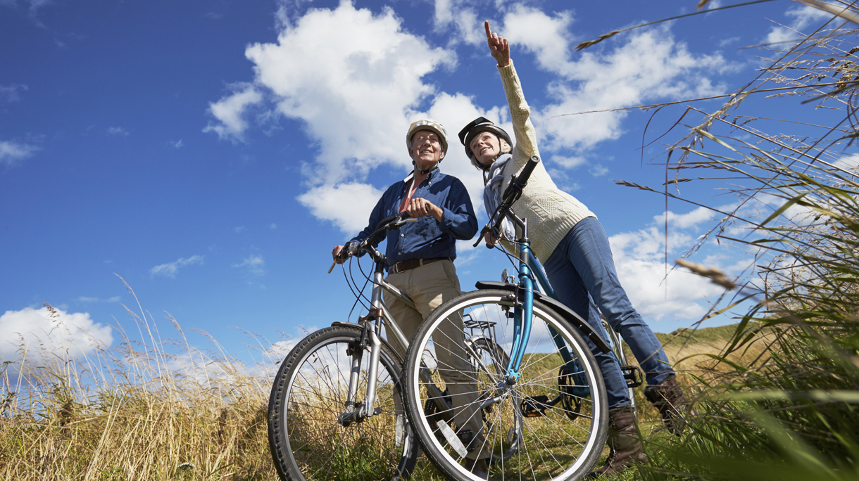 Senior Couple Cycling Through Countryside Together