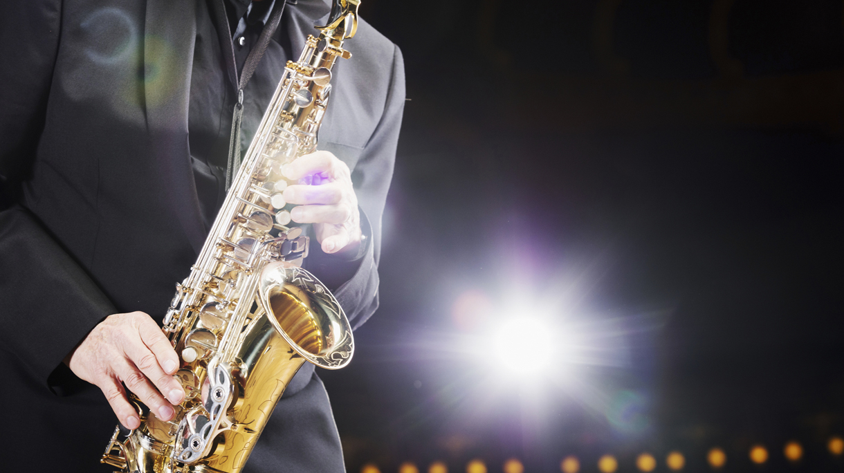 Close up of a saxophone player with backlight