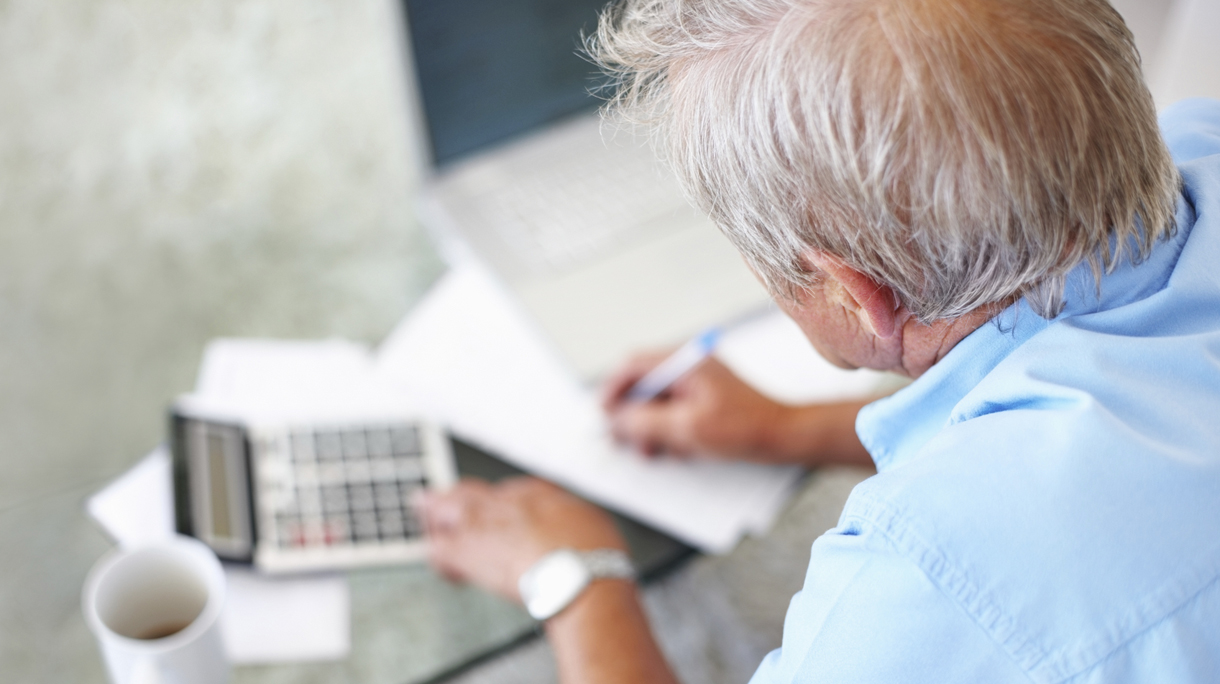 Rear view of a senior man calculating financial budget