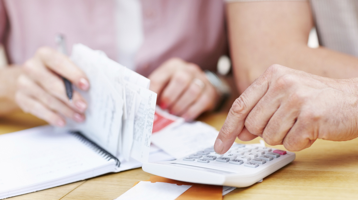 Senior man calculating expenses with woman