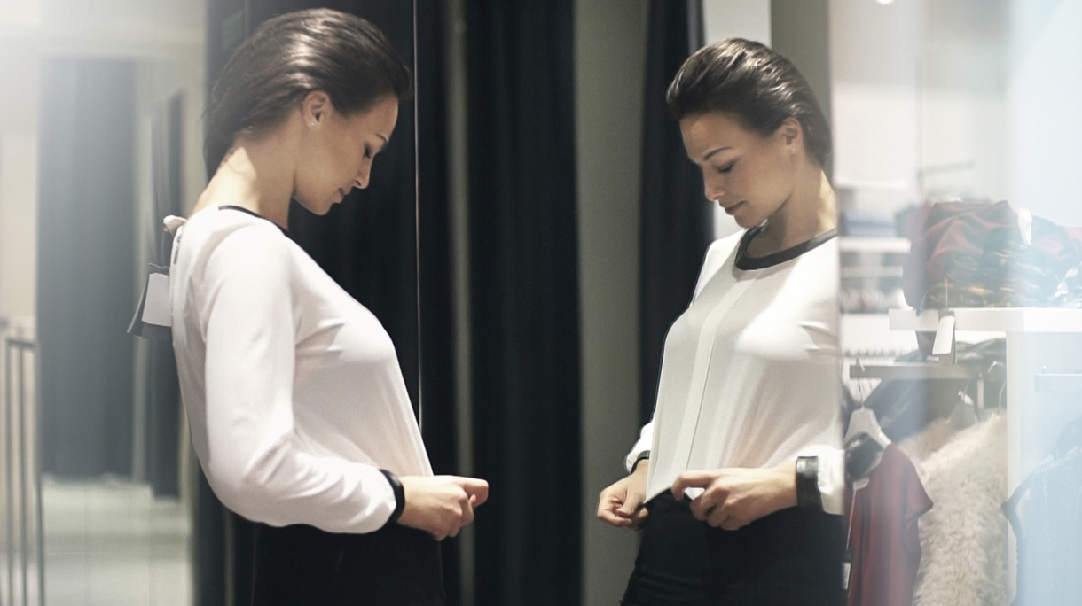 Woman trying on some clothes at a retail store.