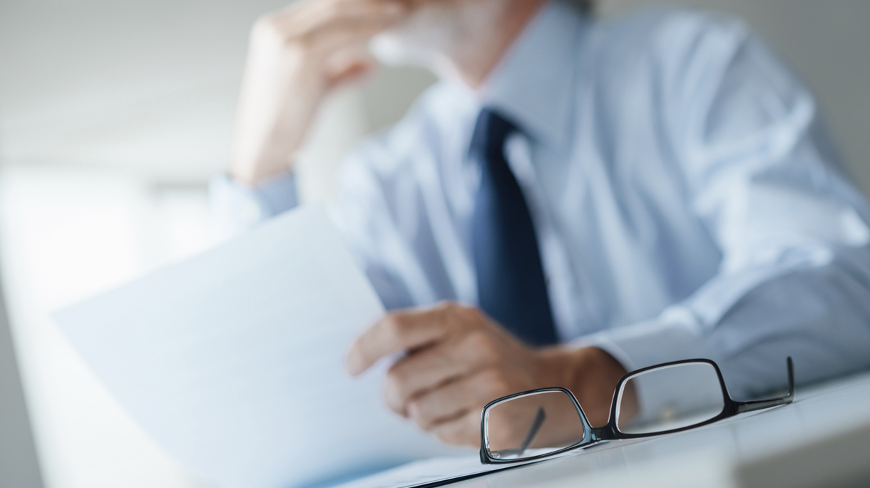 Pensive businessman reading a contract
