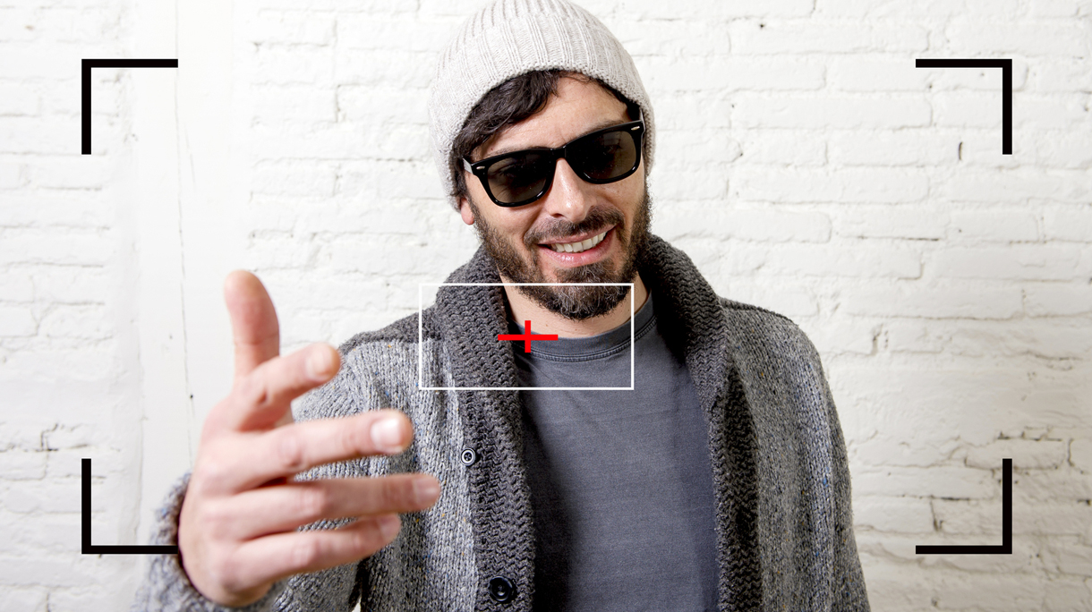 young hipster blogger man recording internet selfie video for blog