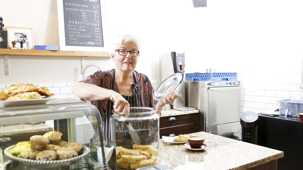 Senior working in coffee shop