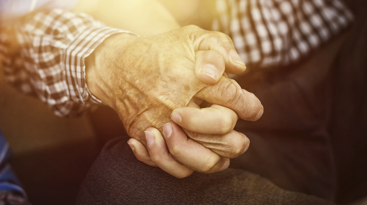 nephew holding strong grandfather’s hand