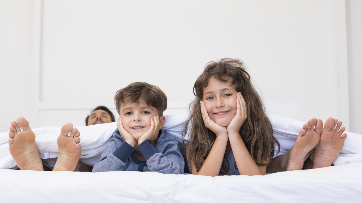 Happy children on bed