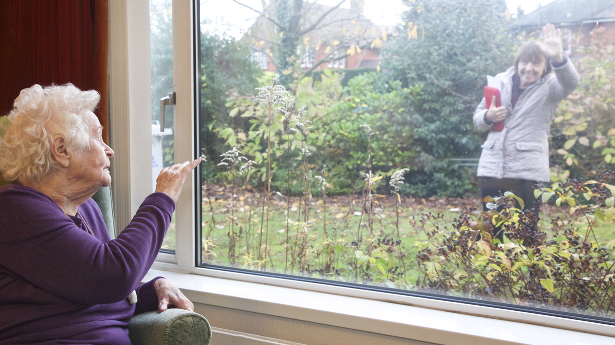 Living with dignity independently – elderly client waving goodbye