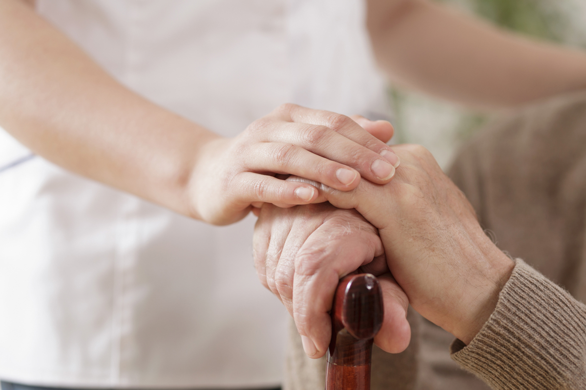 Nurse assisting ill elder man
