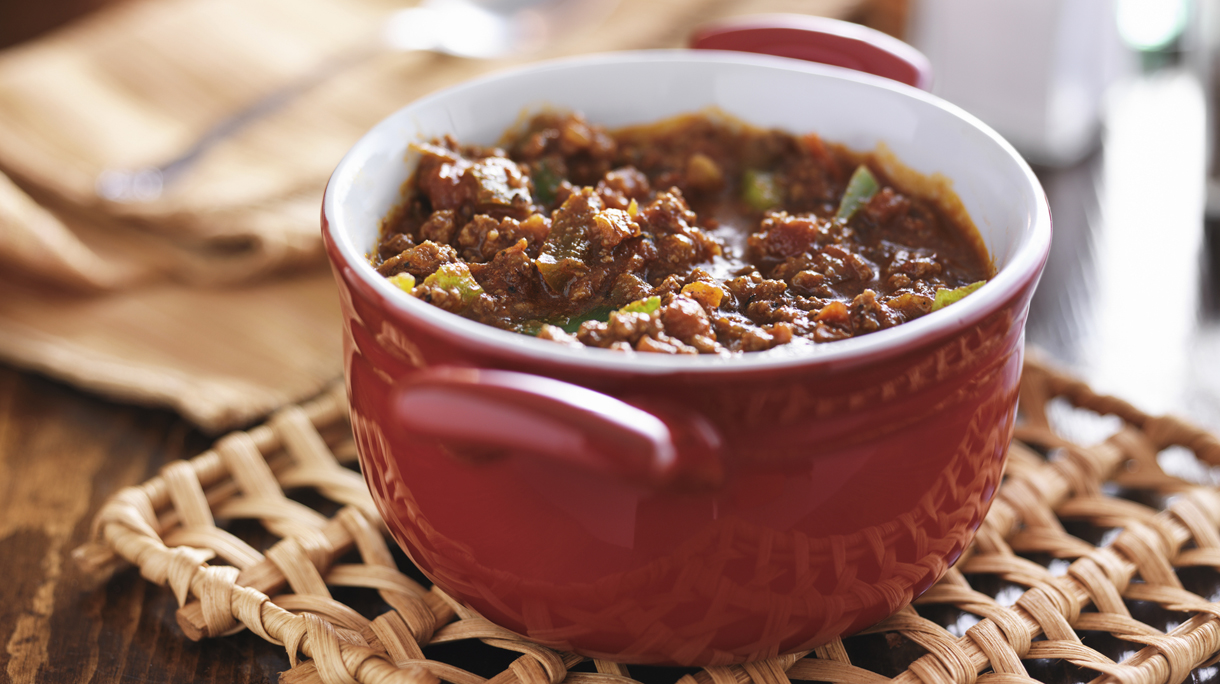 red dish with meaty beef chili and bell peppers
