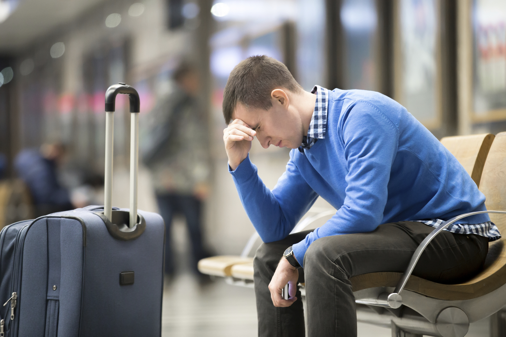 Young frustrated man at airport