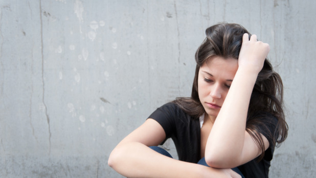 Teenage girl looking thoughtful about troubles