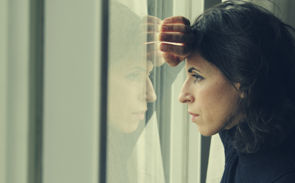 beautiful 35 year old woman stands in front of the window