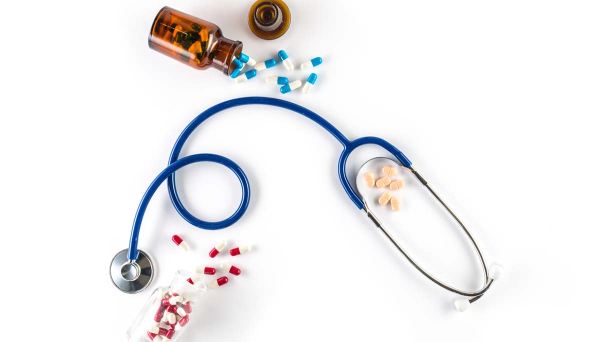 capsule in bottle with Stethoscope and pill cardiology