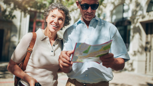 Mature man and woman using  map while sightseeing.