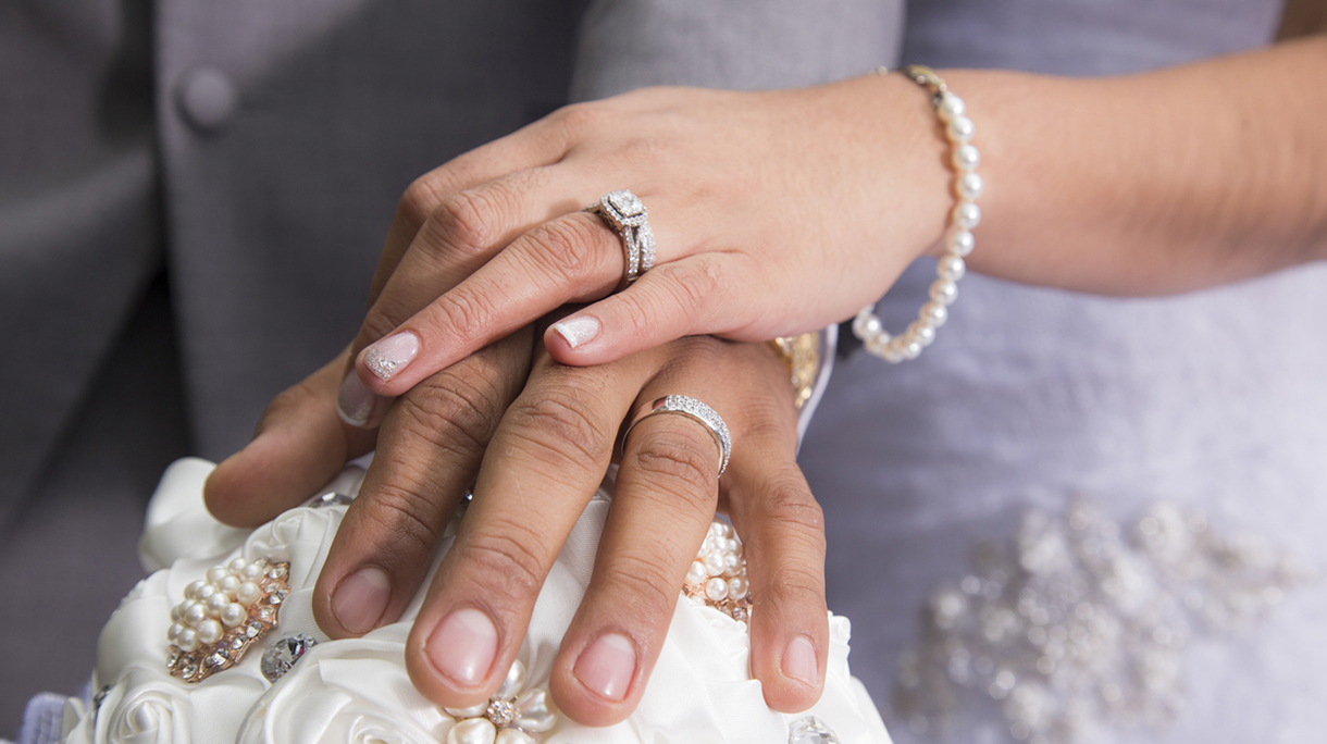 Just married couple showing rings