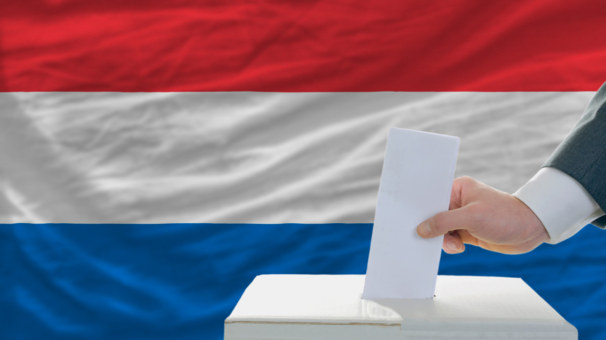 man voting on elections in netherlands front of flag