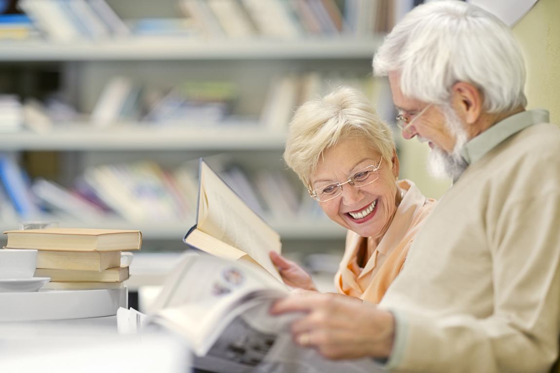 Senior couple in coffee shop have fun and reading
