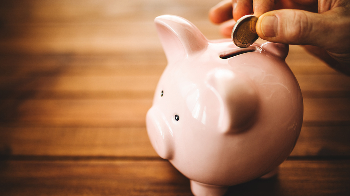 inserting coin on the vintage piggy bank