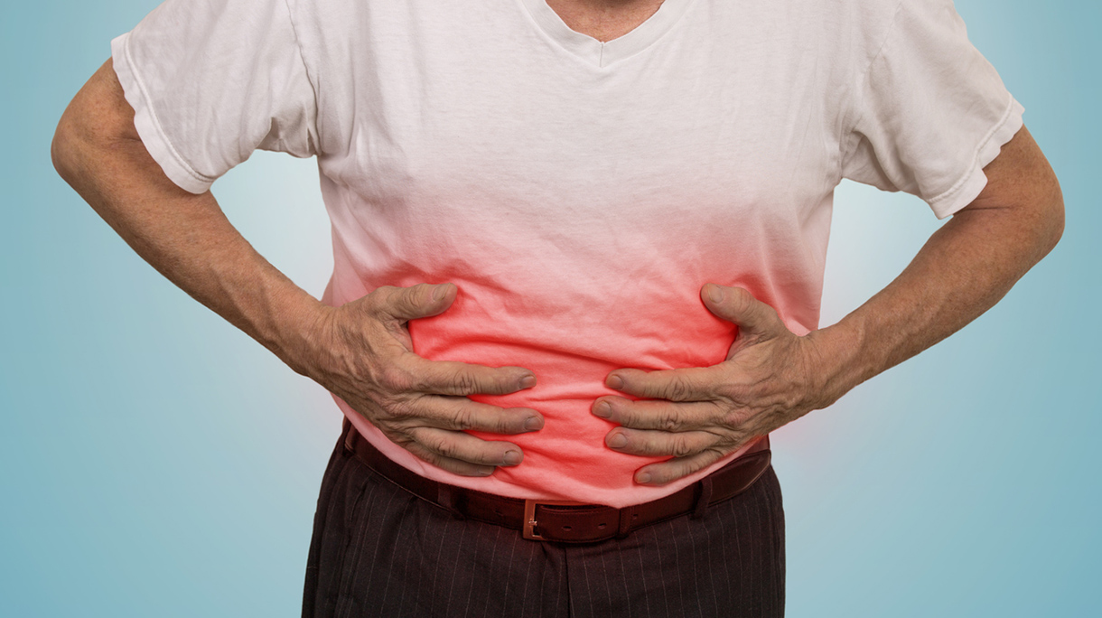 Stomach ache, man placing hands on the abdomen