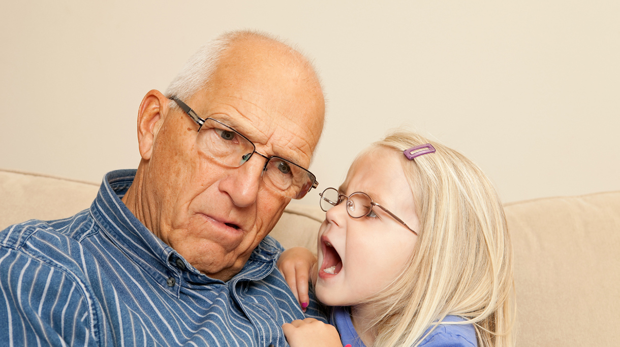 Child Girl Yelling into Grandfather’s Ear