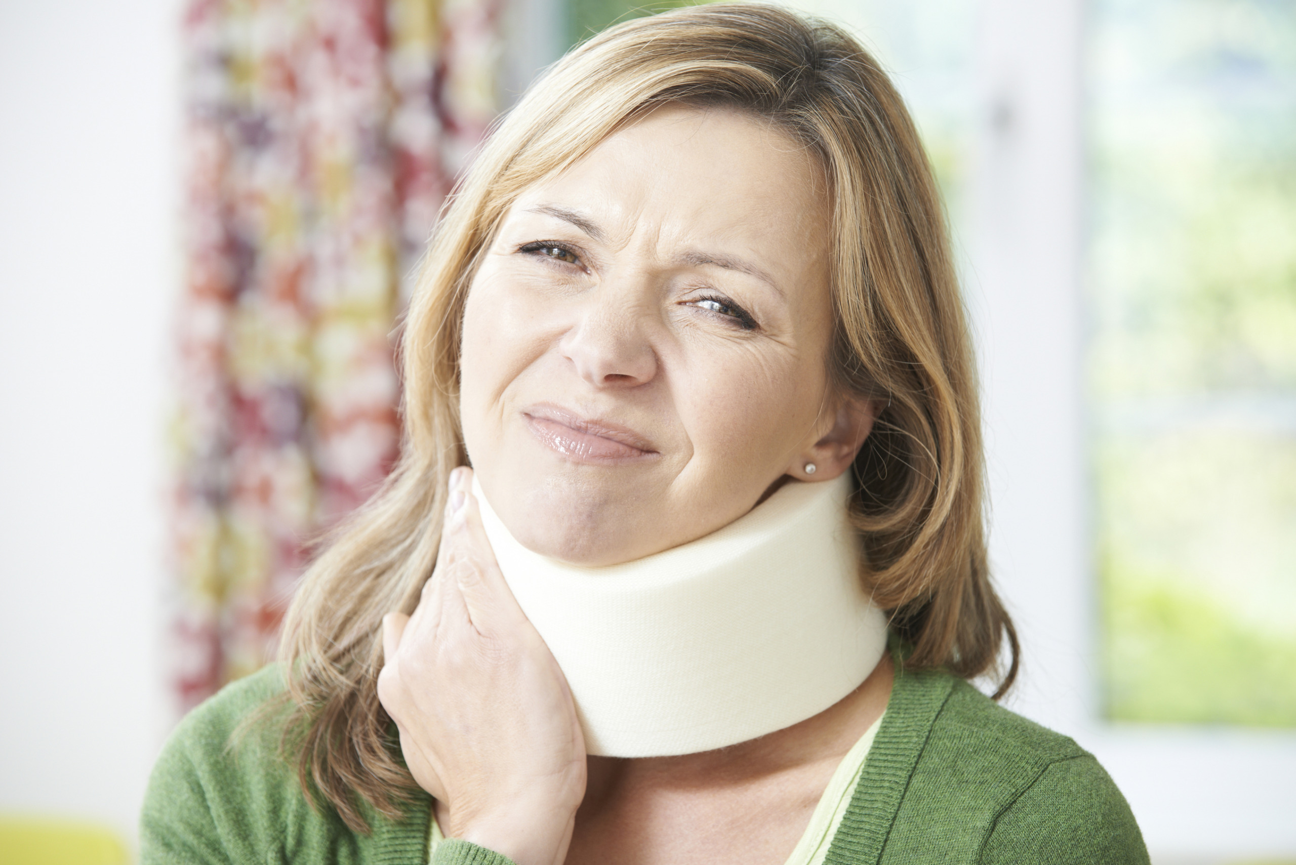 Woman Reading Letter After Receiving Neck Injury