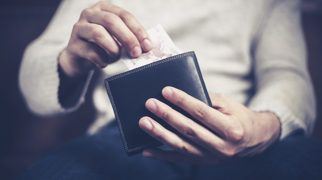 Man getting money out of his wallet