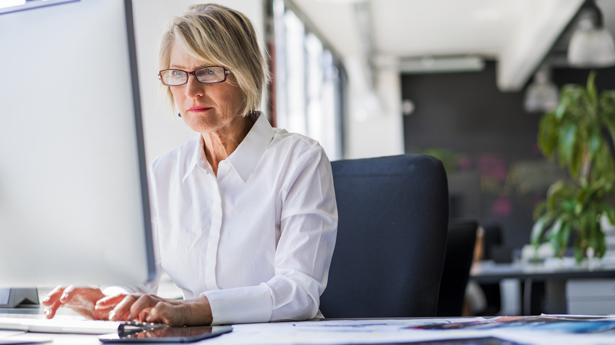 Businesswoman using computer at desk in office