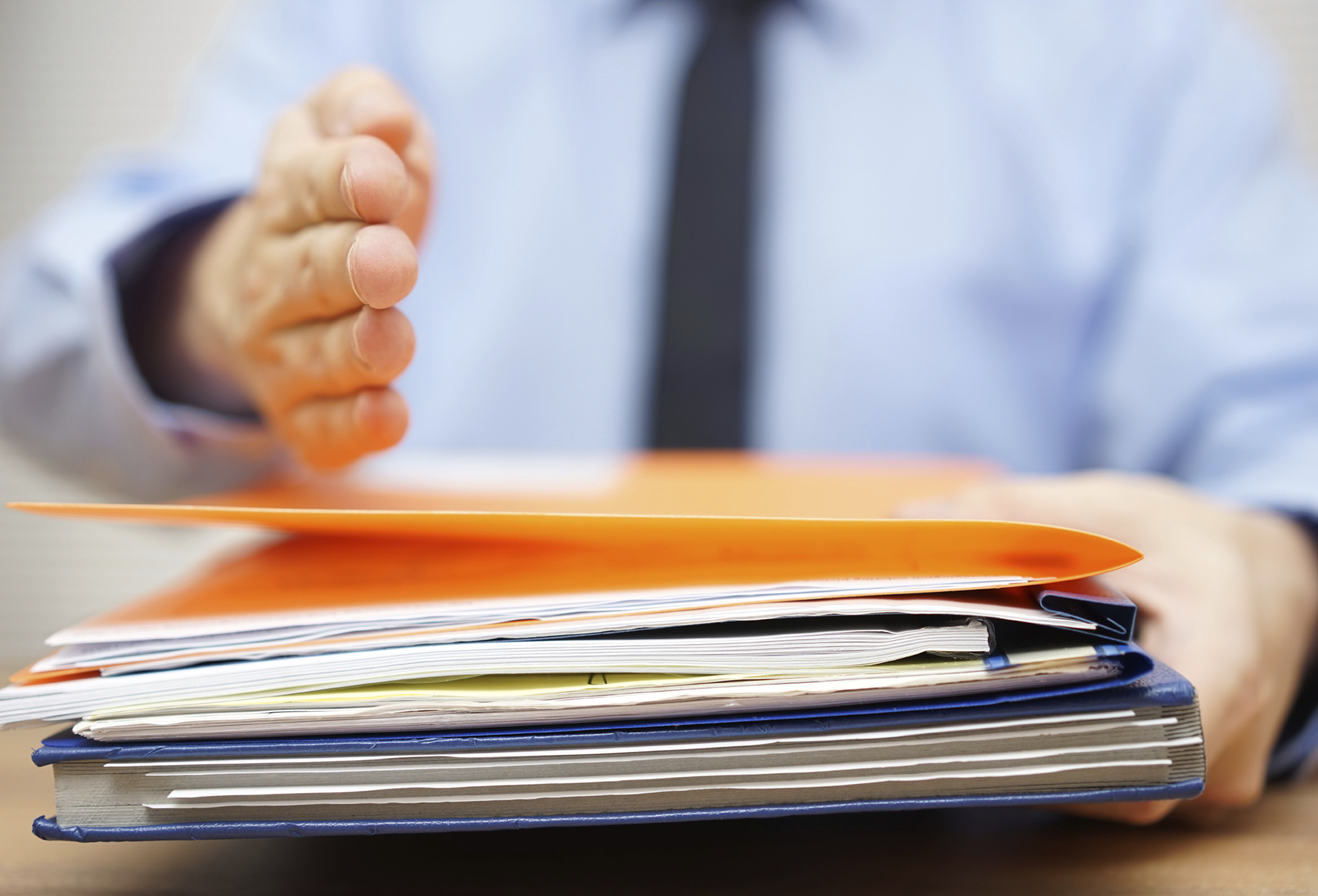 businessman is offering hand to his partner if he accept documen