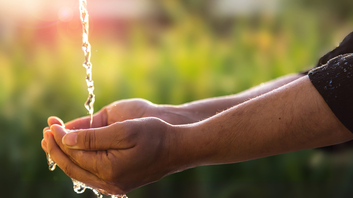 Child’s Hands Under Water Tap