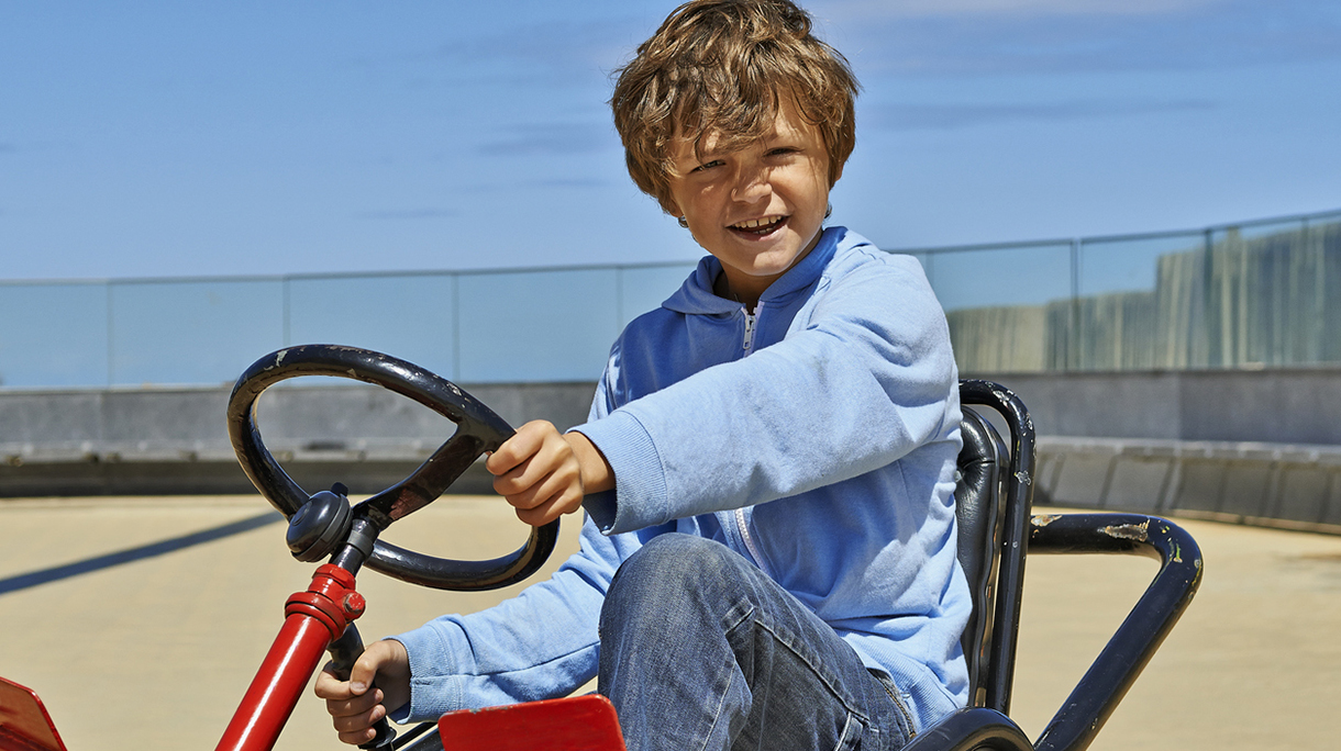 Young boy driving a Quadricycle