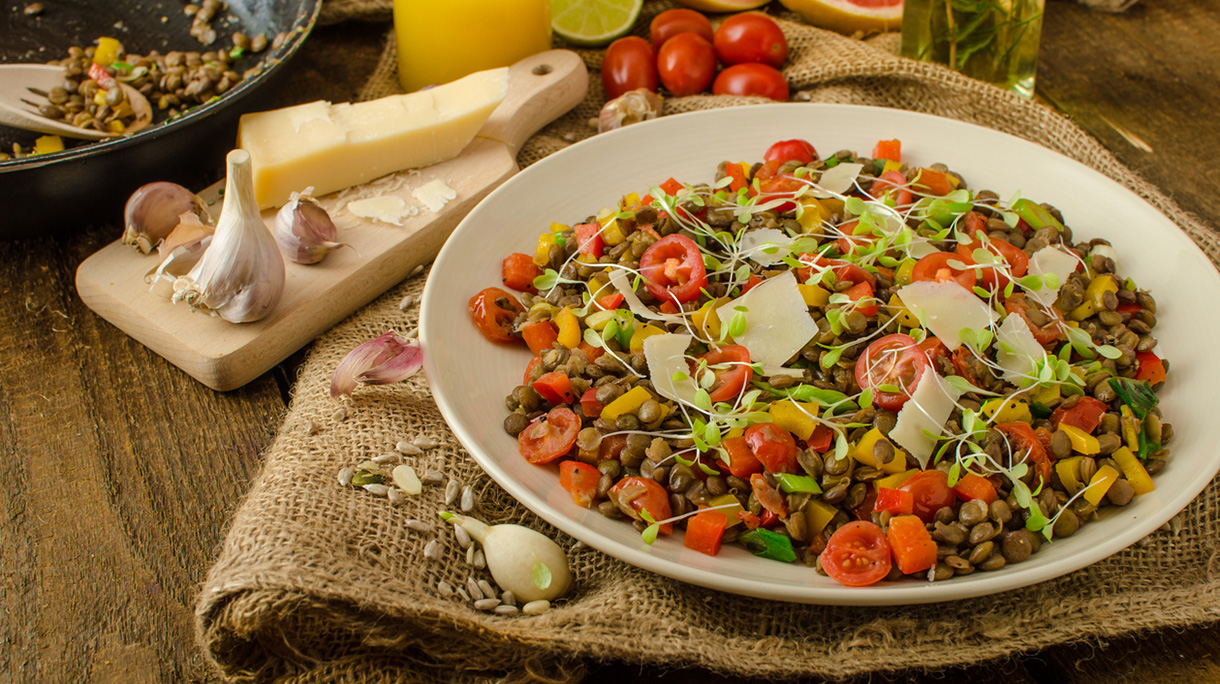 Healthy salad with lentils on wooden table