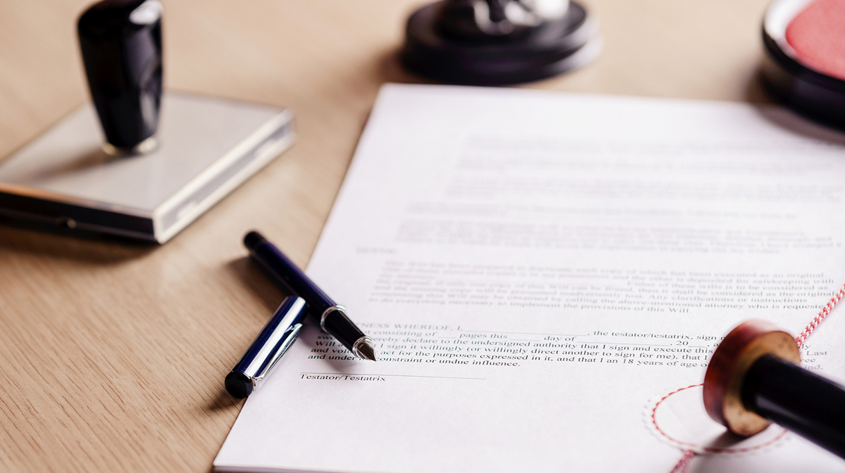 Notary pen lying on testament.