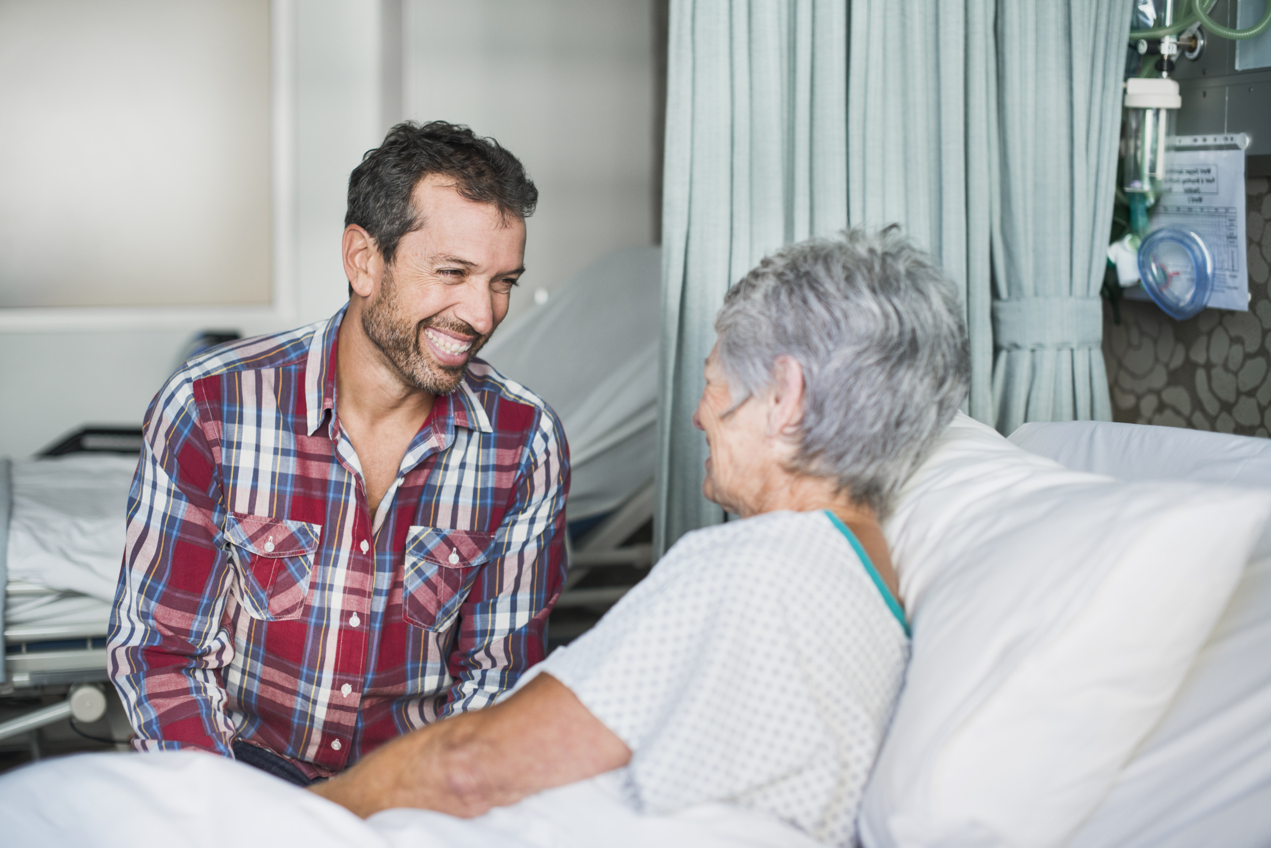 Son visiting his mother in hospital