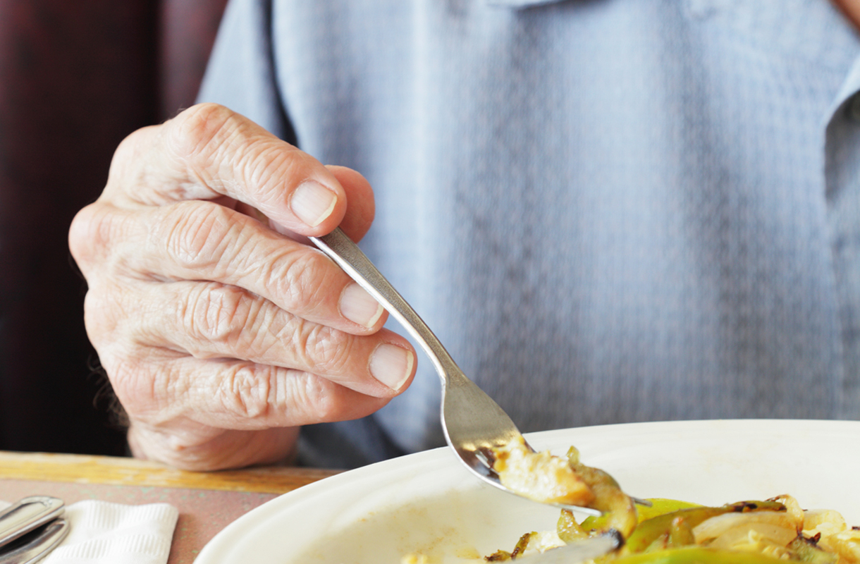 Senior Man Fingers Holding Breakfast Fork Close-Up