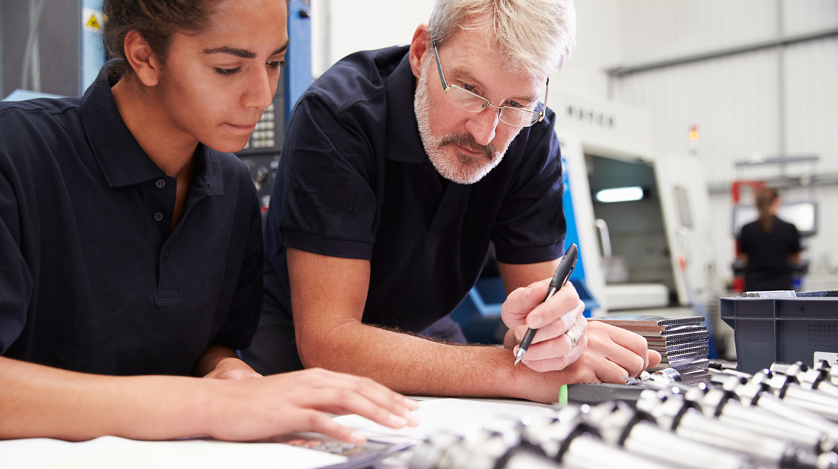 Engineer And Apprentice Planning CNC Machinery Project
