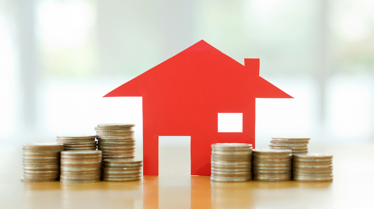 Mortgage concept by money house from the coins