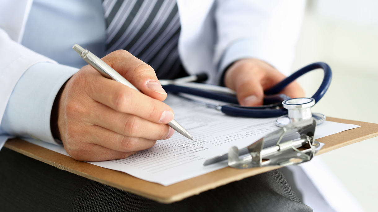 Male medicine doctor hand holding silver pen writing
