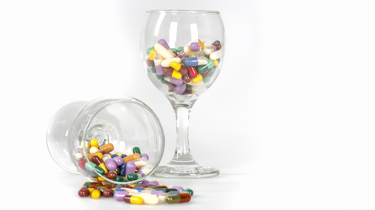 Champagne glass full of Medicine pills.