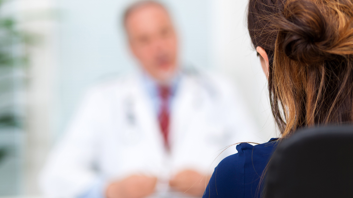 Doctor talking to a patient in his office