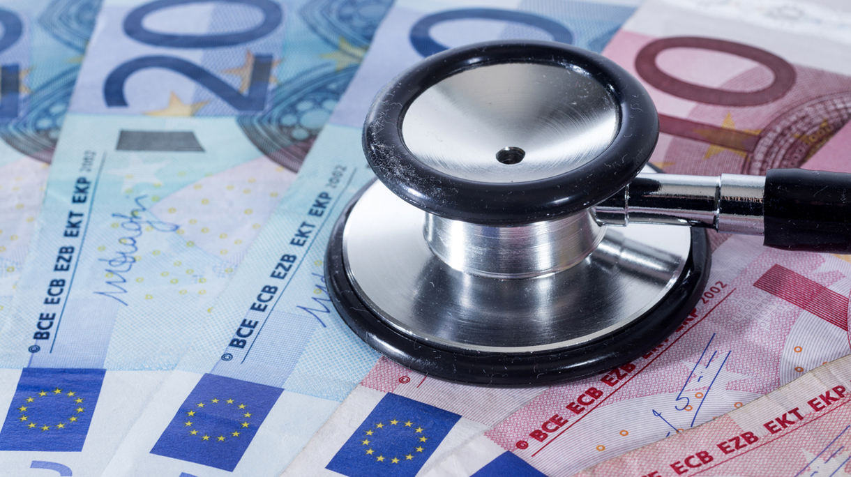 Euro banknotes, coins and stethoscope
