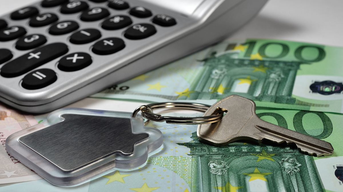 Calculator, money and house key