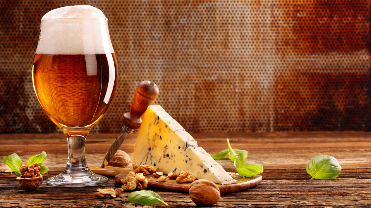 Blue cheese appetizer and beer on brown vintage background